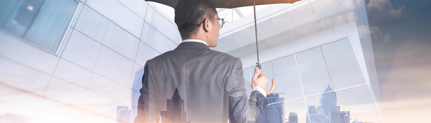 Businessmen are spreading umbrella during sunrise overlay with cityscape image. The concept of modern life